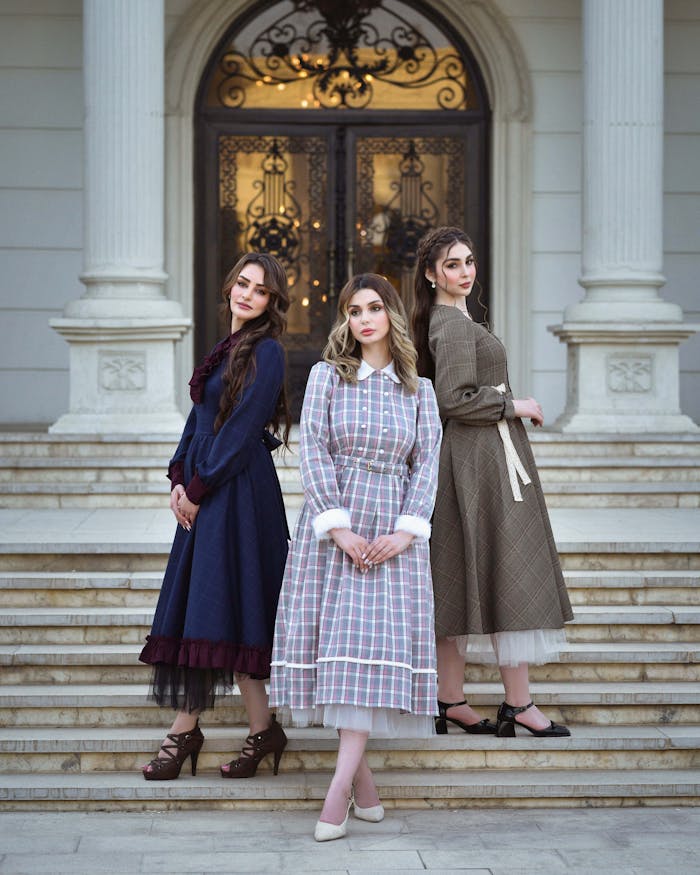 gallery-4 Three women in vintage dresses pose gracefully on manor steps. Beautiful and elegant fashion portrait.